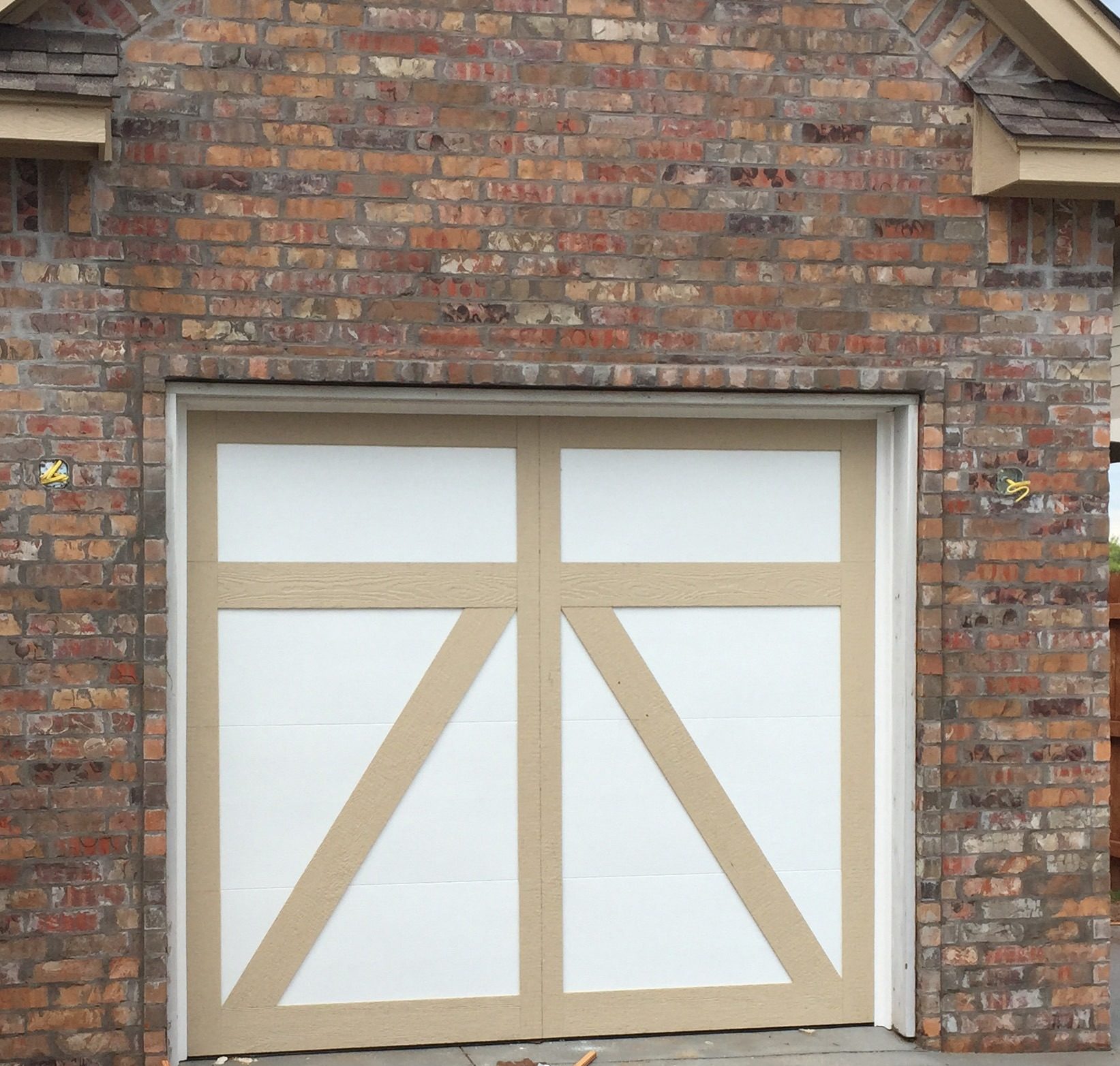 wood tone garage door with an overlay